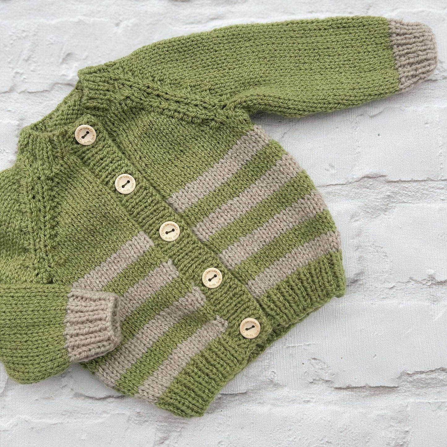 Hand knitted personalised baby cardigan in green and stone , newborn — made to order in the UK | Little Name Knits