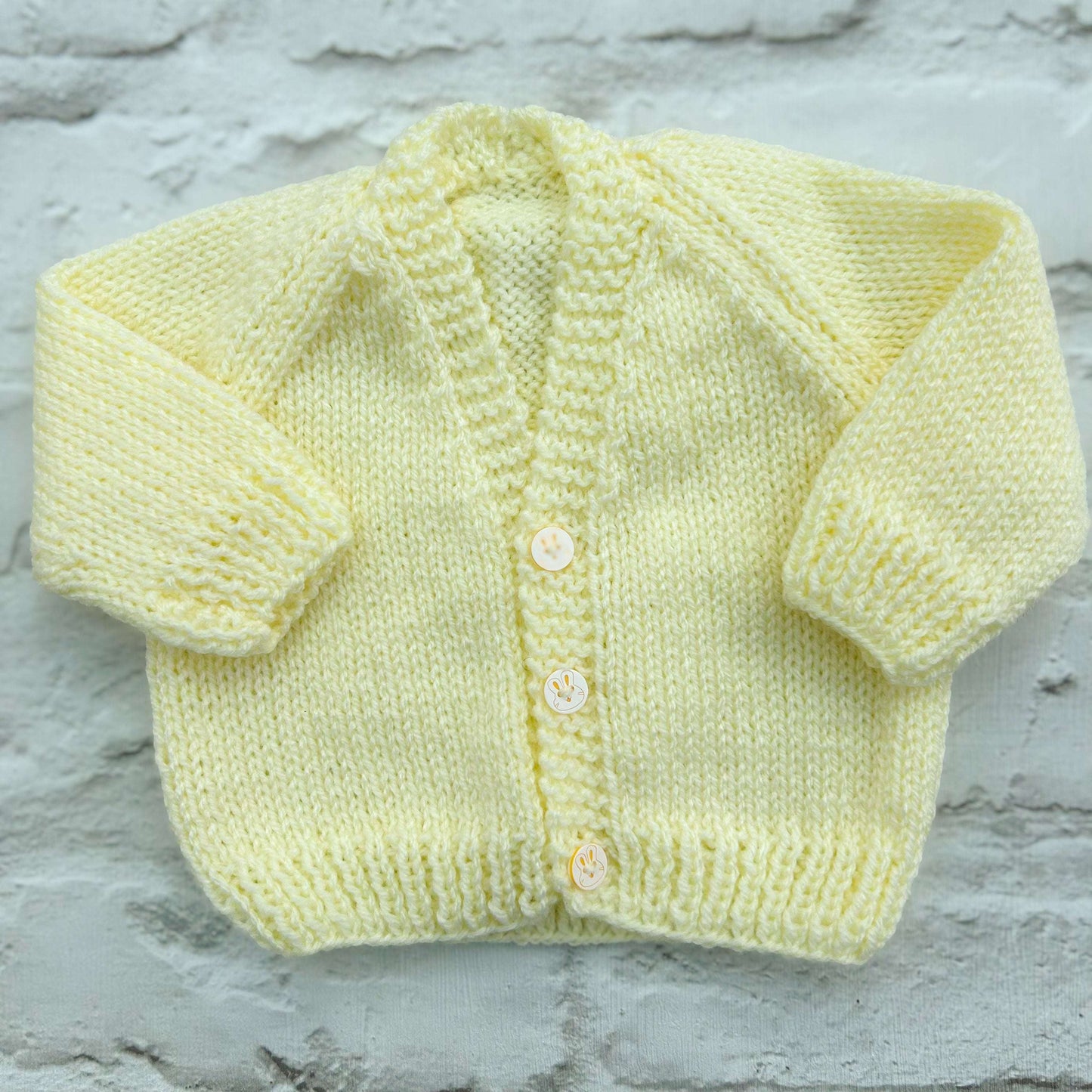 Hand knitted personalised baby cardigan in lemon, newborn — made to order in the UK | Little Name Knits