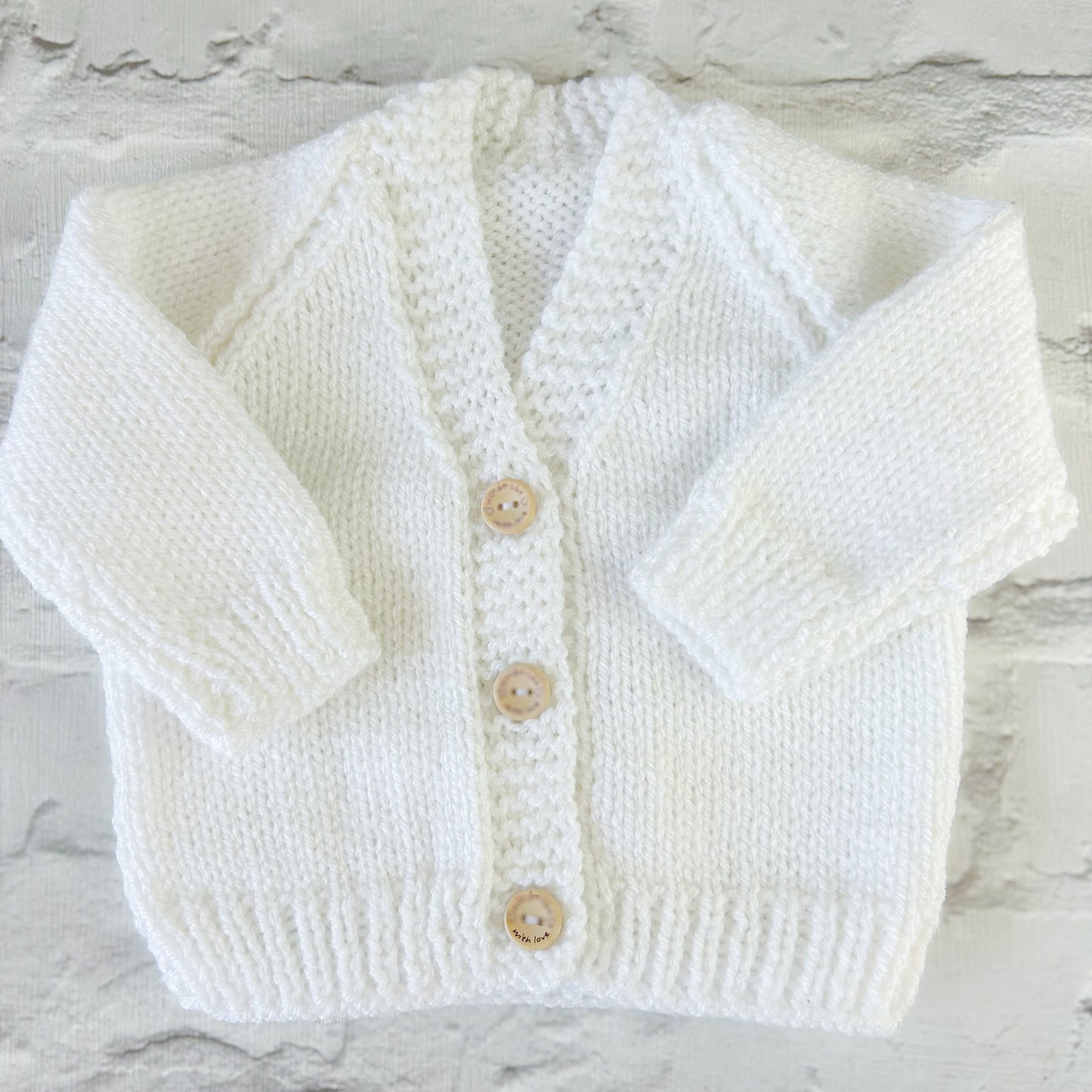 Hand knitted personalised baby cardigan in white, 0-3 months — made to order in the UK | Little Name Knits
