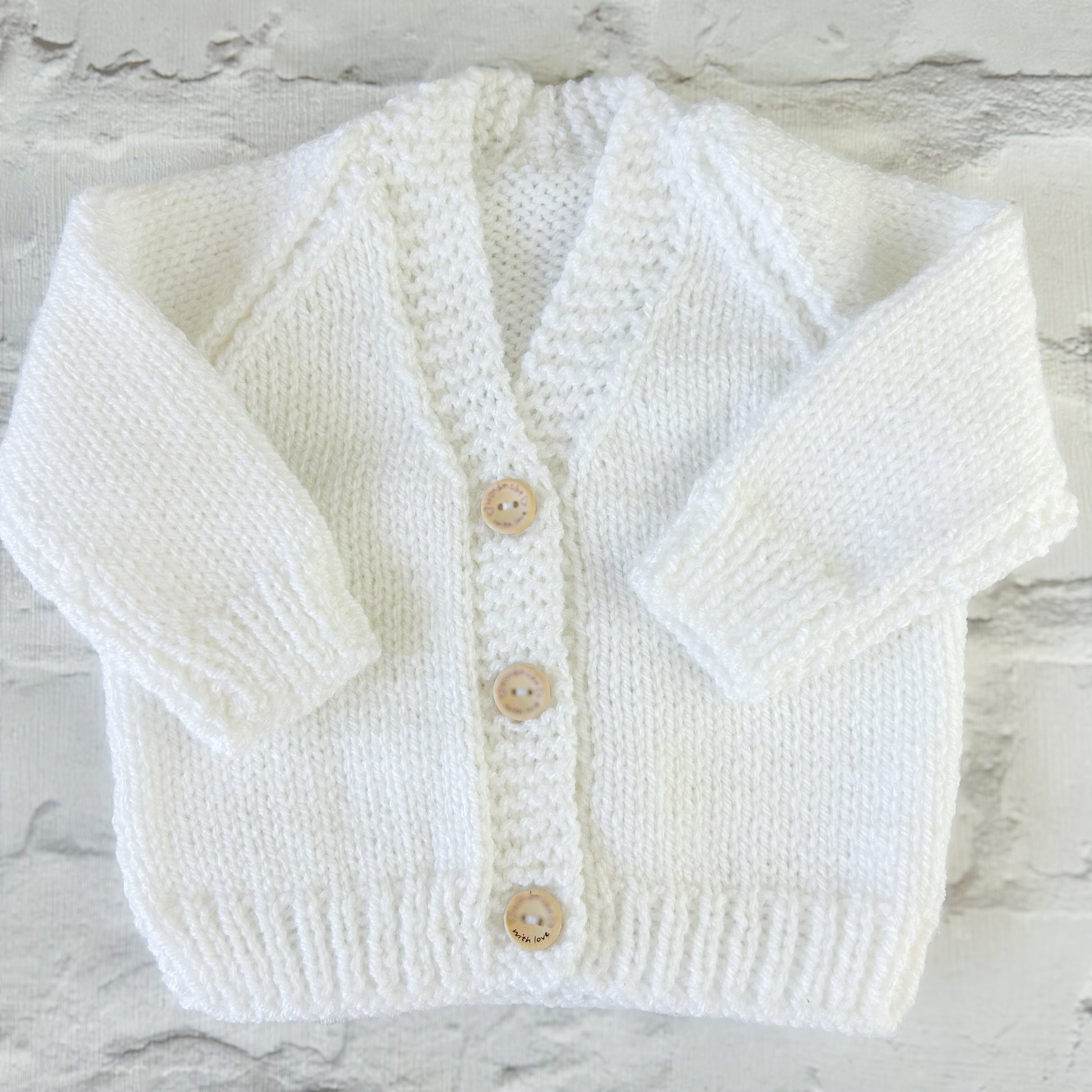 Hand knitted personalised baby cardigan in white, 0-3 months — made to order in the UK | Little Name Knits