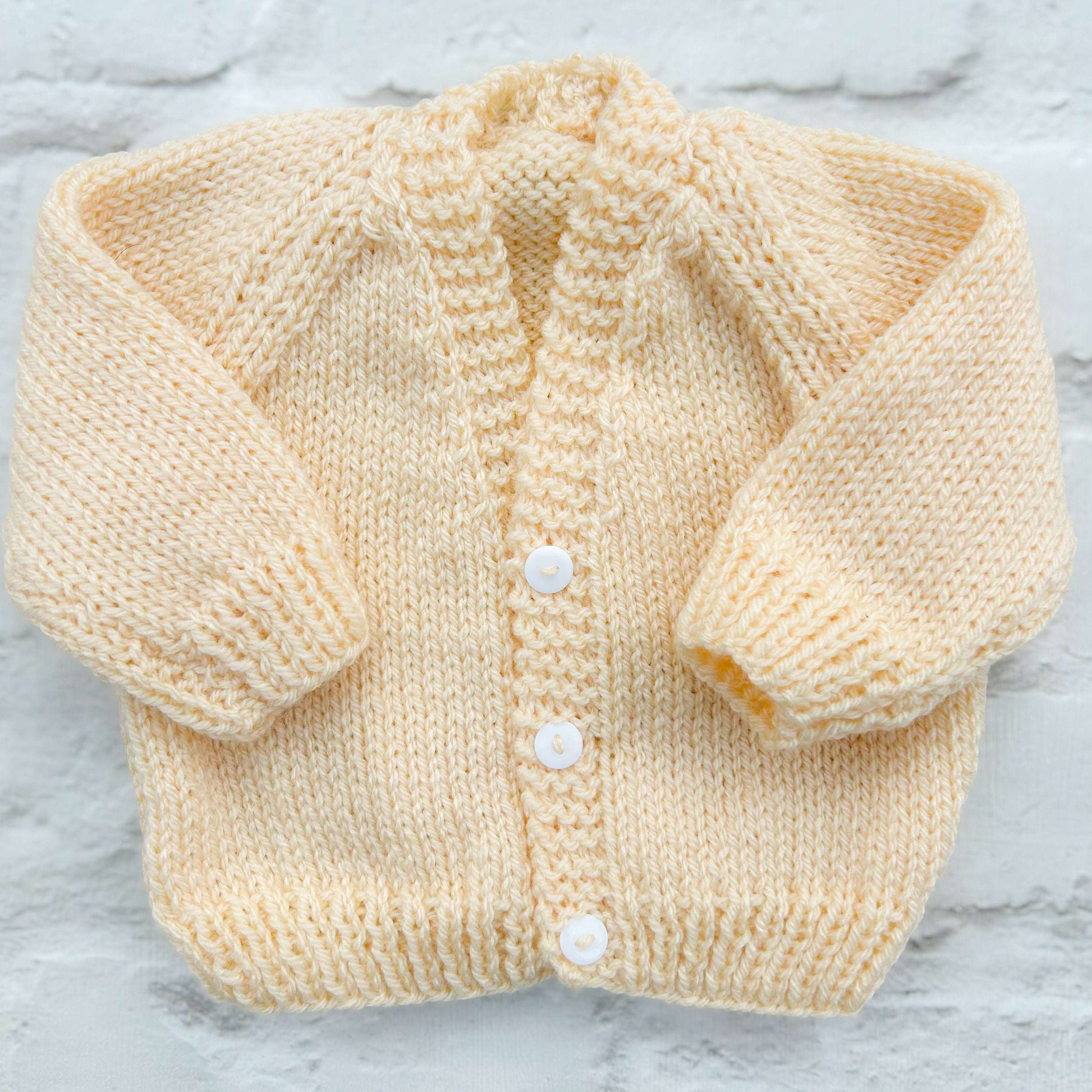 Hand knitted personalised baby cardigan in biscuit colour, newborn — made to order in the UK | Little Name Knits