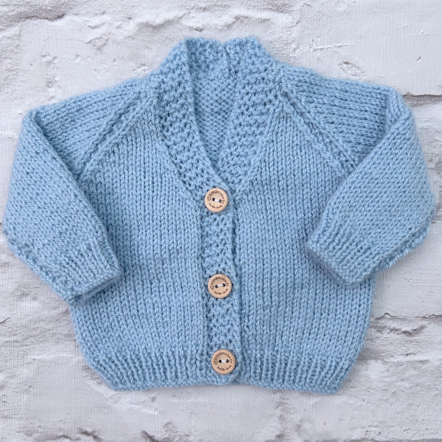 Hand knitted personalised baby cardigan in baby blue, size newborn — made to order in the UK | Little Name Knits