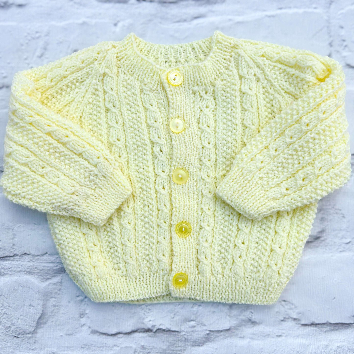 Hand knitted personalised baby cardigan in lemon cable knit, size 0-3 months — made to order in the UK | Little Name Knits
