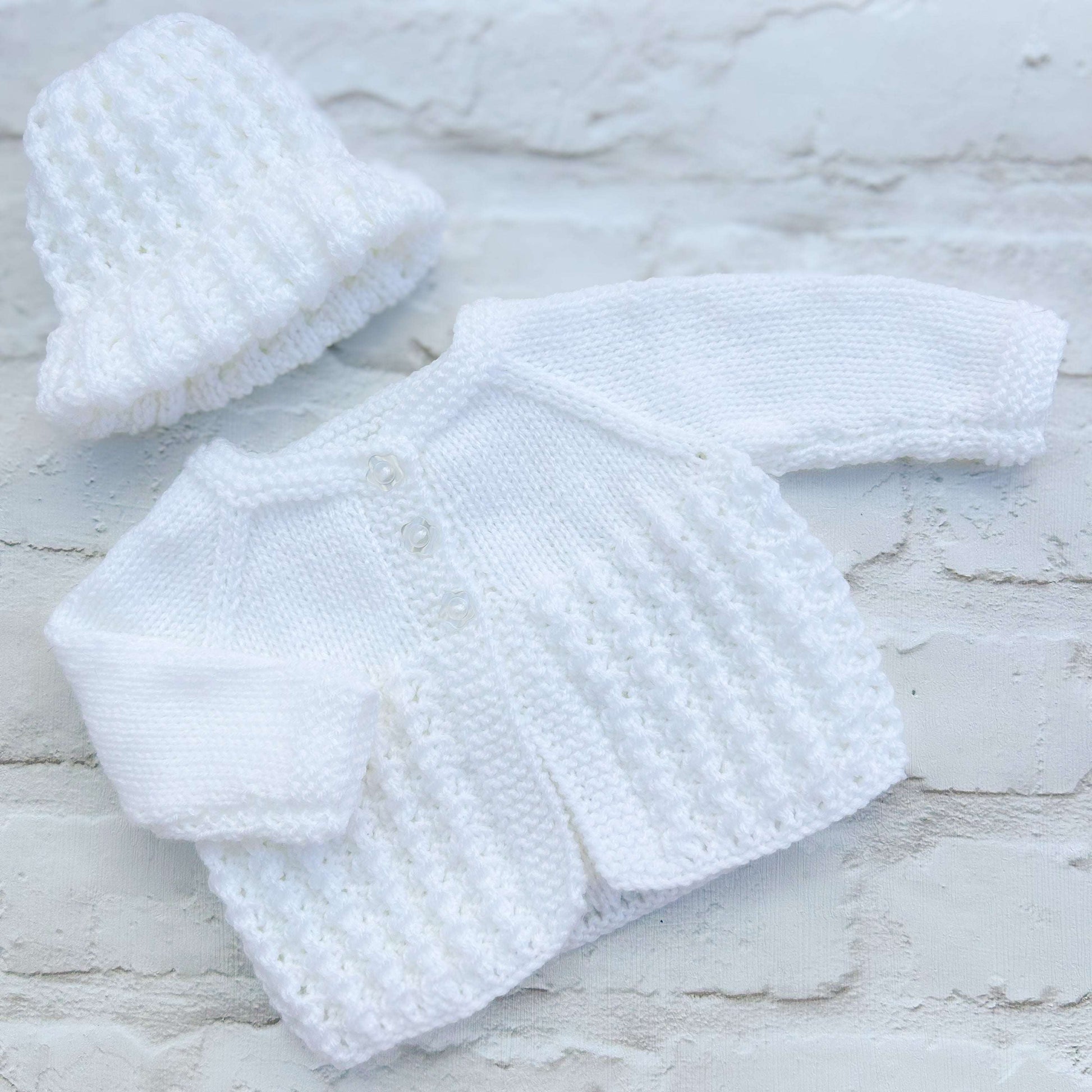 Hand knitted personalised baby cardigan with matching hat in white, size 0-3 months — made to order in the UK | Little Name Knits