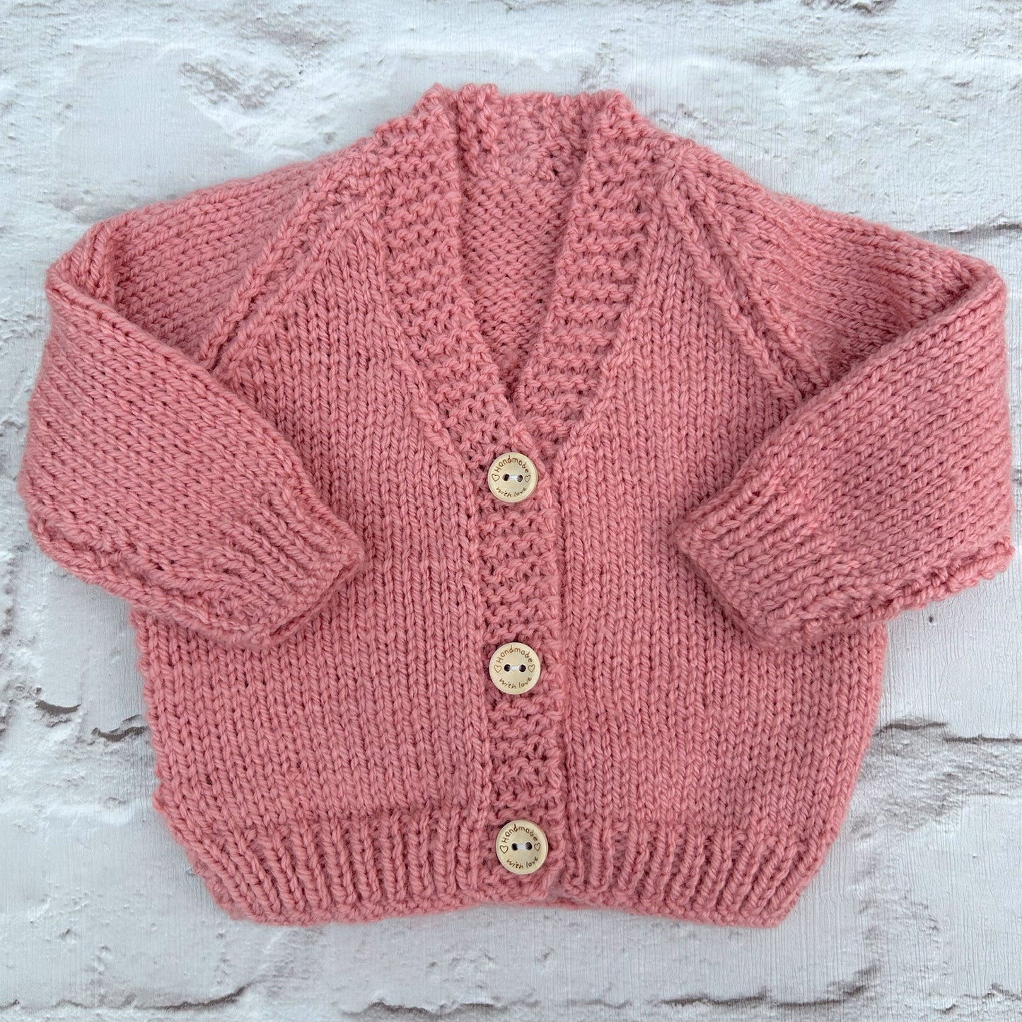 Hand knitted personalised baby cardigan in rose pink, size newborn — made to order in the UK | Little Name Knits
