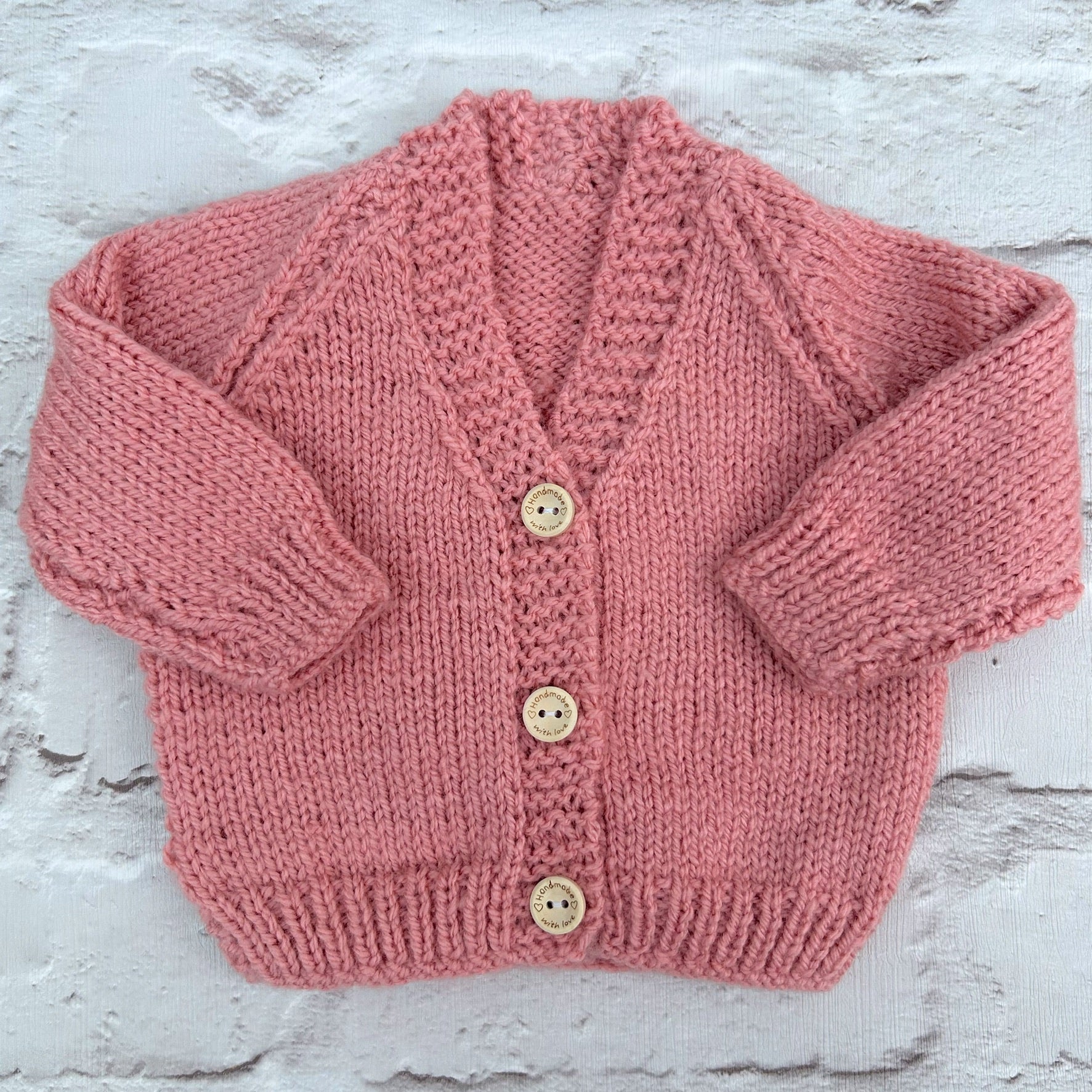 Hand knitted personalised baby cardigan in rose pink, size newborn — made to order in the UK | Little Name Knits