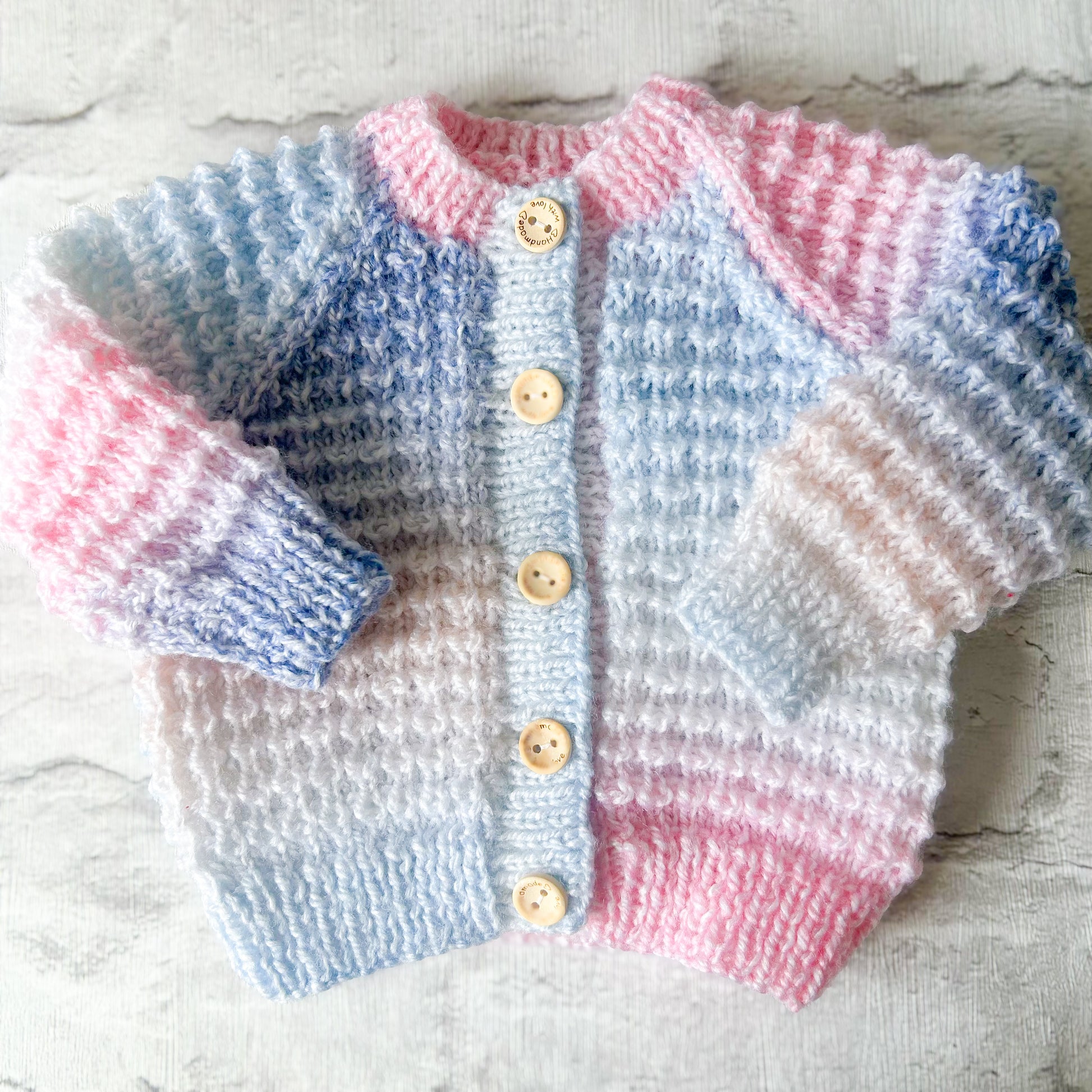 Hand knitted personalised baby cardigan in rainbow pastel colours size Newborn — made to order in the UK | Little Name Knits