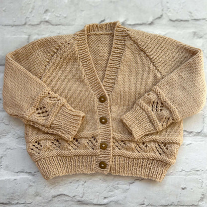 Hand knitted personalised baby cardigan in beige size 12-18 months — made to order in the UK | Little Name Knits

