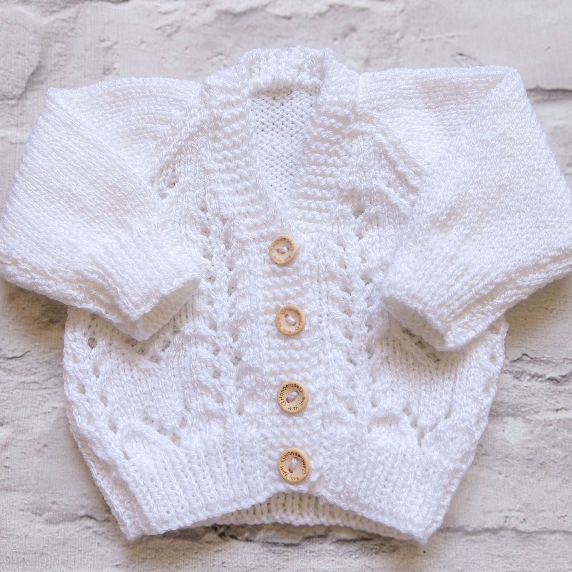 Hand knitted personalised baby cardigan in textured white, newborn size — made to order in the UK | Little Name Knits