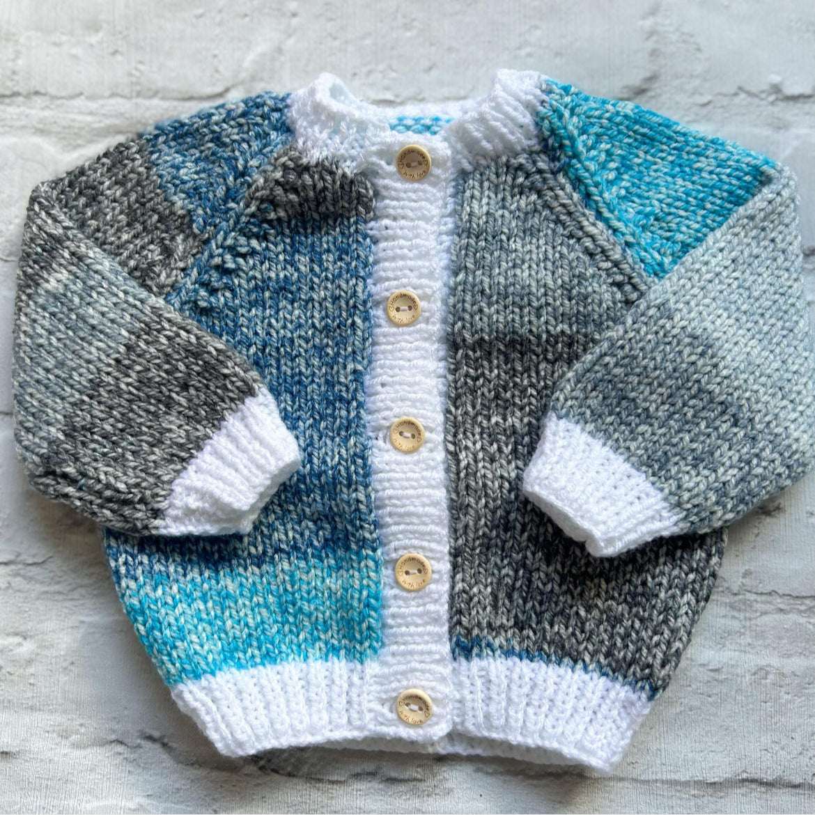 Hand knitted personalised baby cardigan in blue grey and white mix, size 3-6 months — made to order in the UK | Little Name Knits
