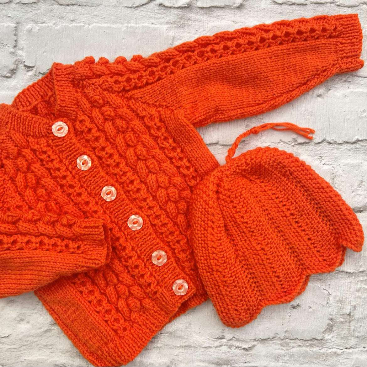 Hand knitted personalised baby cardigan in orange size 3-6 months — made to order in the UK | Little Name Knits