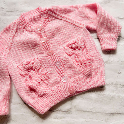 Hand knitted personalised baby cardigan in pink with flower pocket detail size 3-6 months — made to order in the UK | Little Name Knits