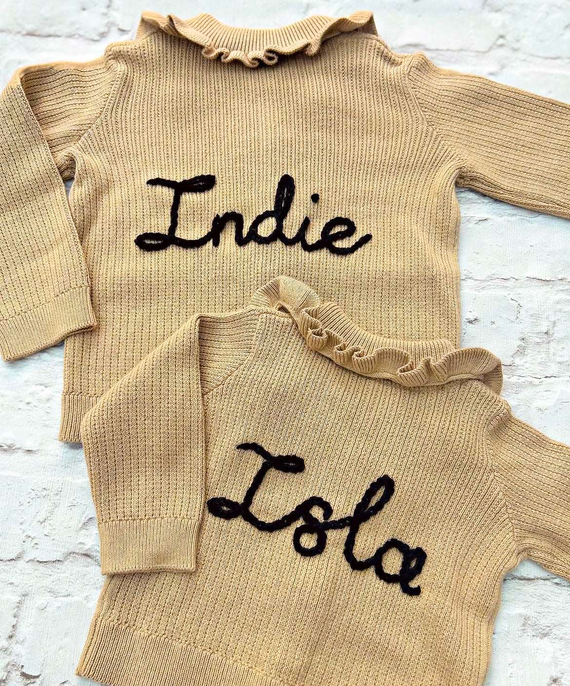 Hand embroidered personalisation on 'H&M' cardigans matching for siblings. Send in service by Little Name Knits - add name to your own knitwear hand knitted or store purchased knitwear