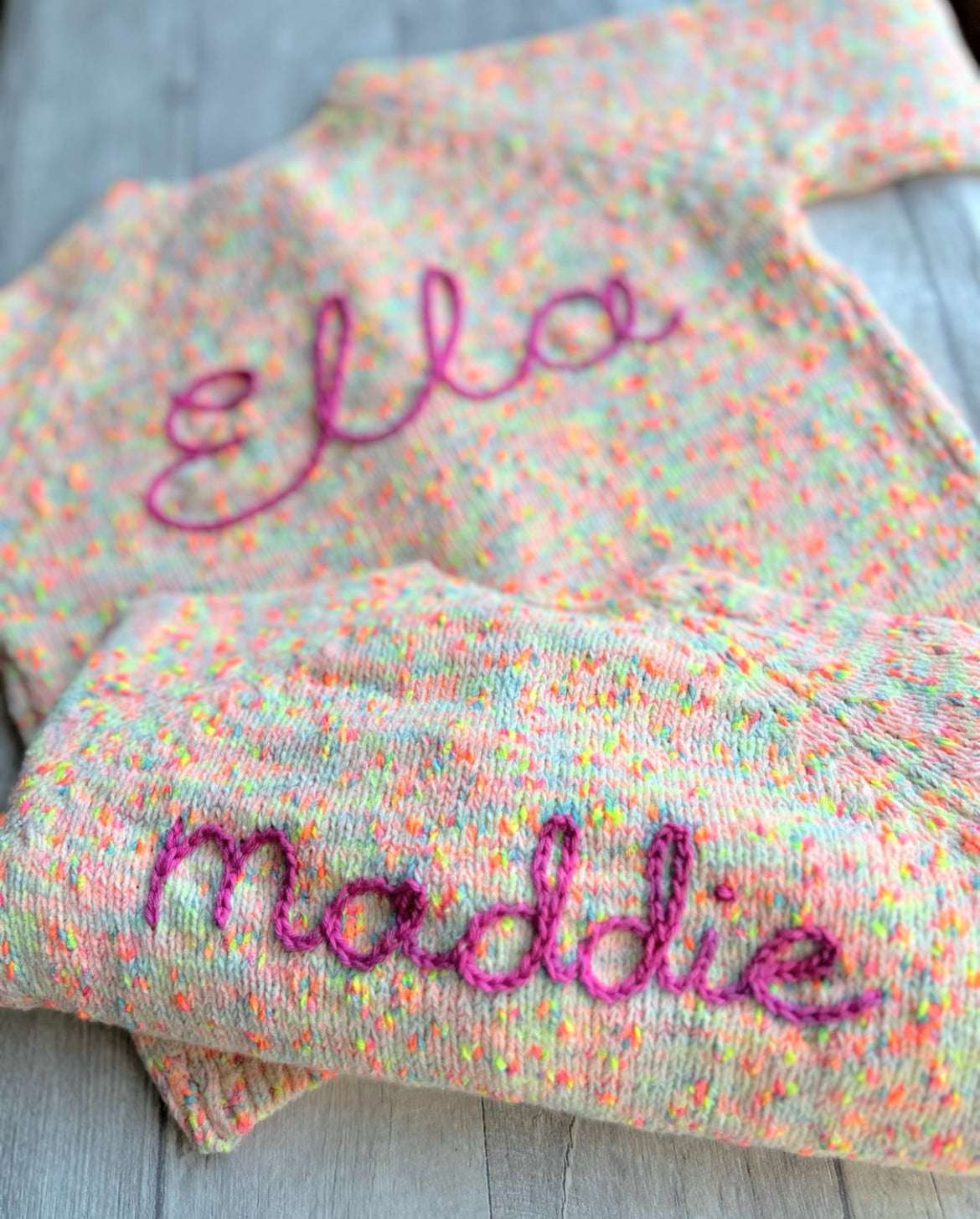 Hand embroidered personalisation on 'NEXT' cardigans matching for siblings. Send in service by Little Name Knits - add name to your own knitwear hand knitted or store purchased