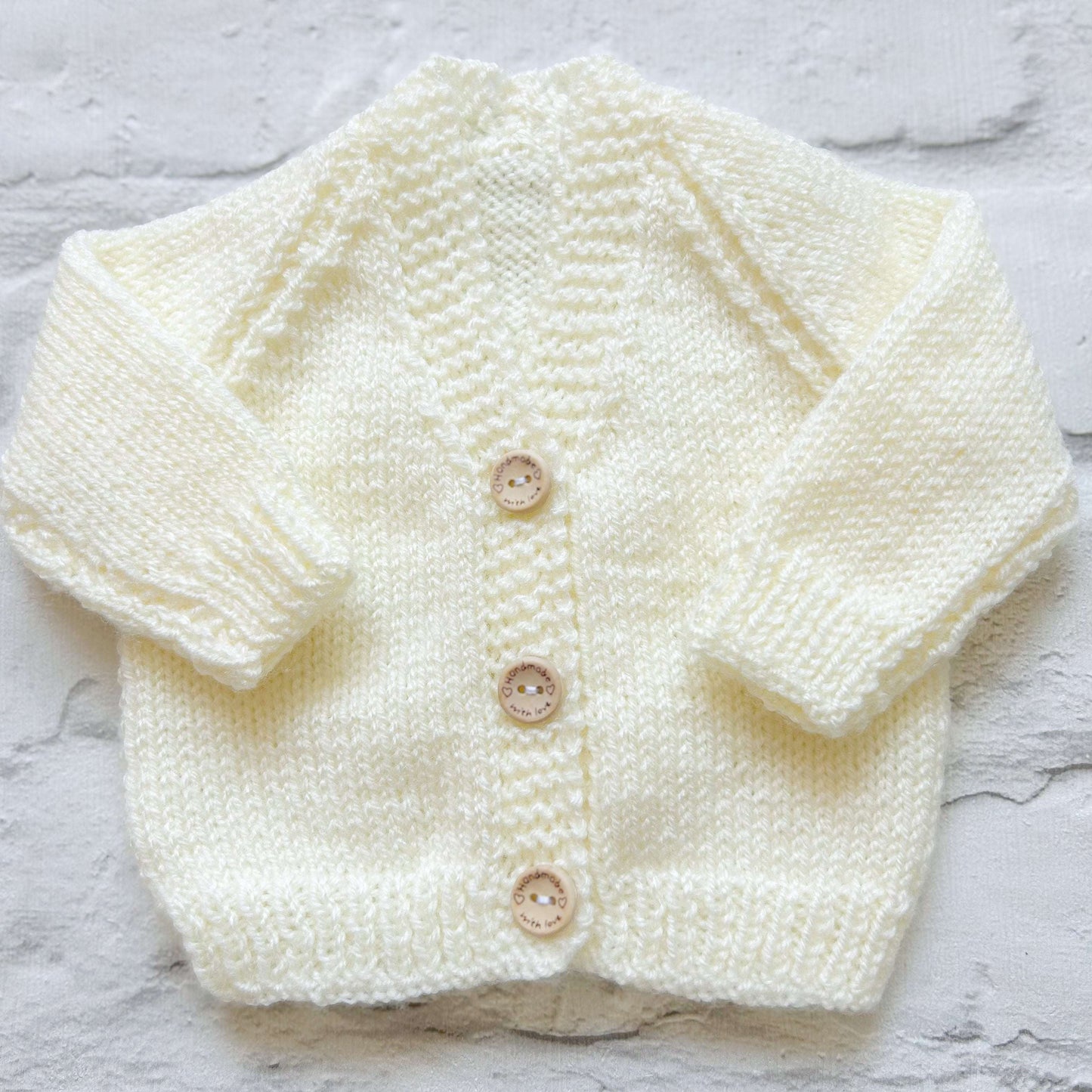 Hand knitted personalised baby cardigan in cream , size newborn  — made to order in the UK | Little Name Knits