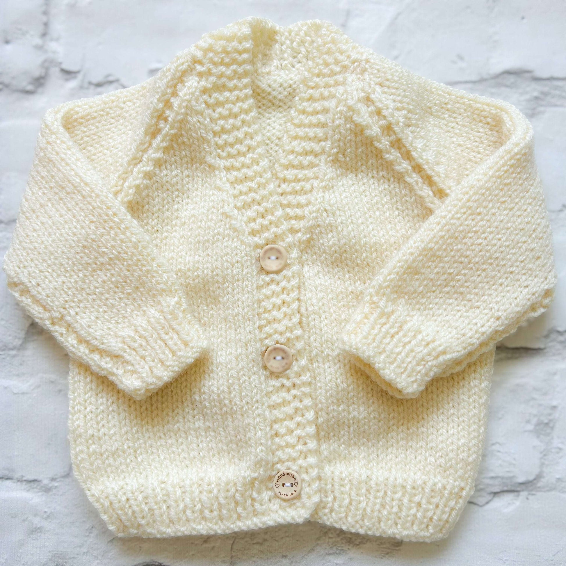 Hand knitted personalised baby cardigan in cream, size 0-3 months — made to order in the UK | Little Name Knits