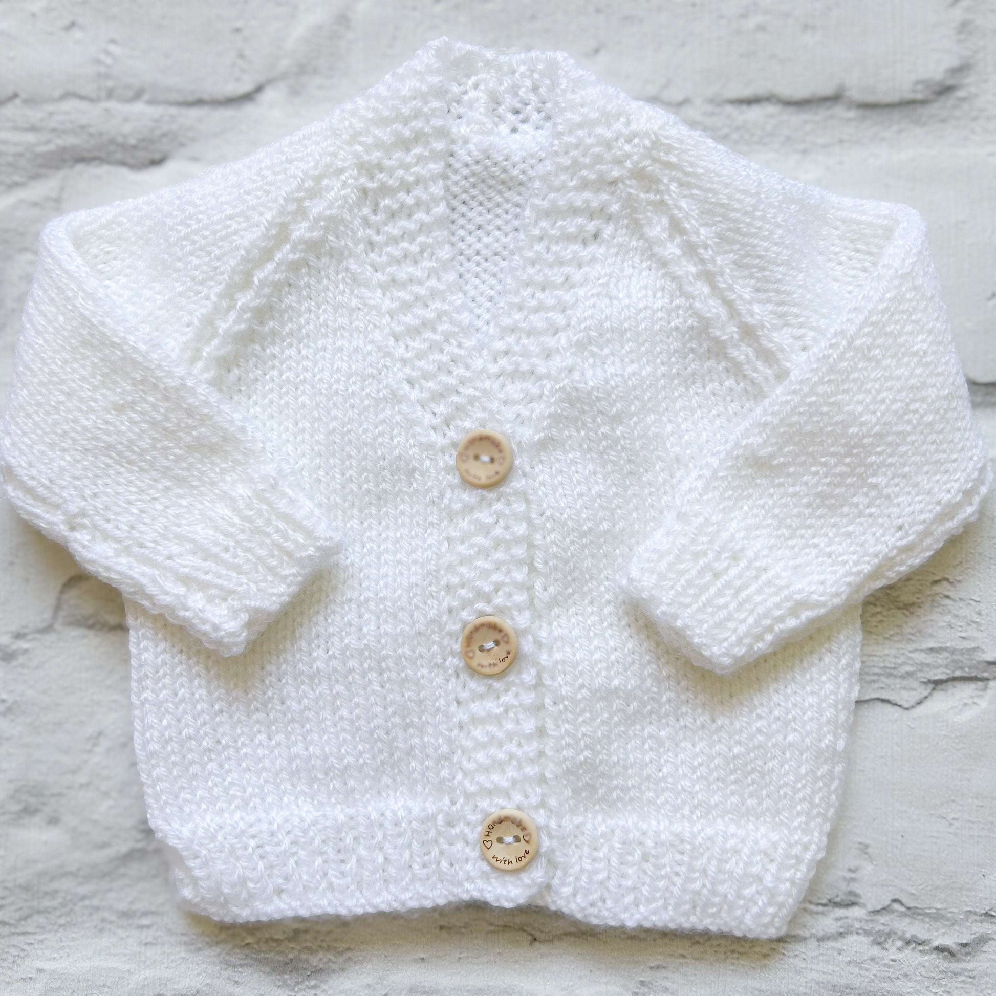 Hand knitted personalised baby cardigan in white, size newborn  — made to order in the UK | Little Name Knits