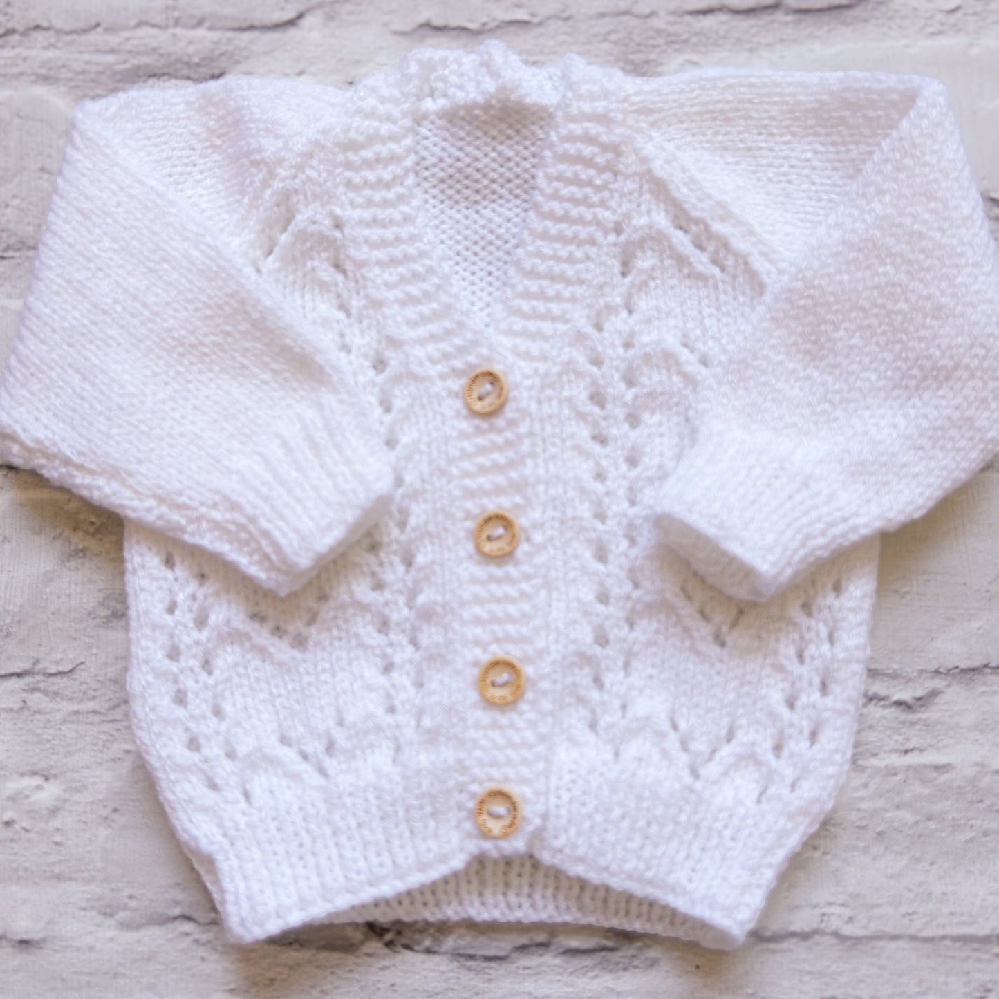 Hand knitted personalised baby cardigan in white, size 0-3 months — made to order in the UK | Little Name Knits