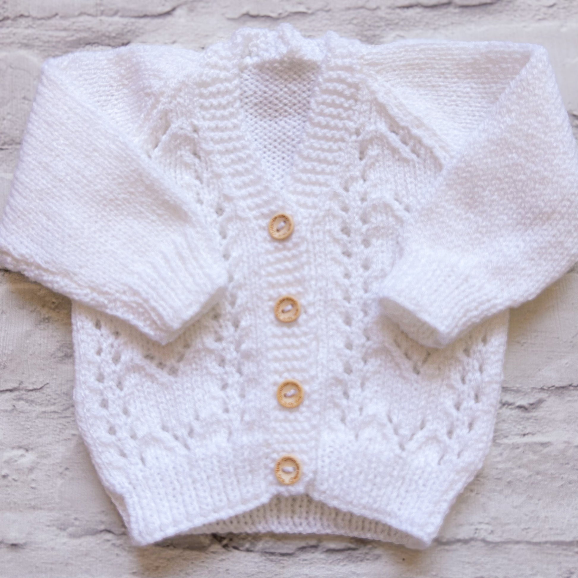 Hand knitted personalised baby cardigan in white, size 0-3 months — made to order in the UK | Little Name Knits